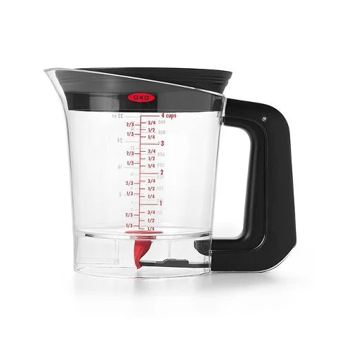 Clear fat separator measuring cup with black handle and OXO logo on a white background