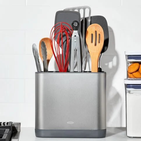 Kitchen utensil holder with various utensils on a kitchen counter