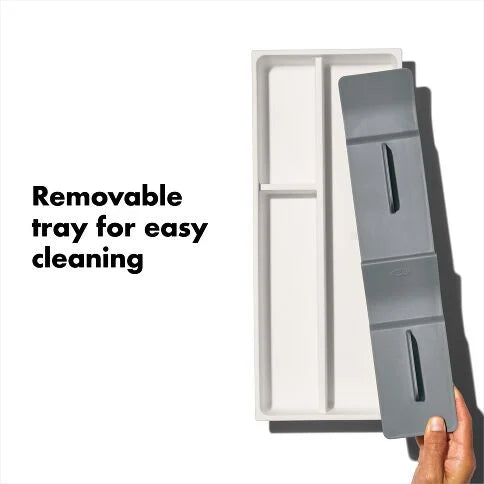 Gray removable tray being held above a white container with text 'Removable tray for easy cleaning'.