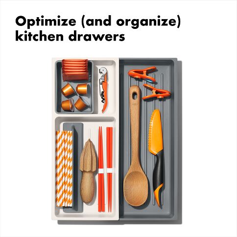 Organized kitchen drawer with utensils and tools on a white background