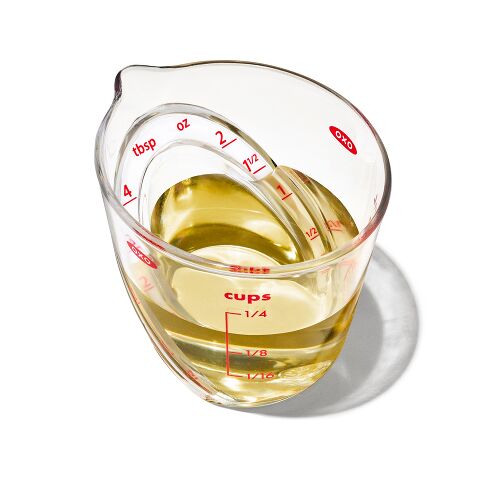 Measuring cup with liquid on a white background