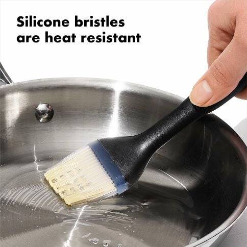 Black silicone brush applying silicone to a pot with text 'Silicone bristles are heat resistant'.