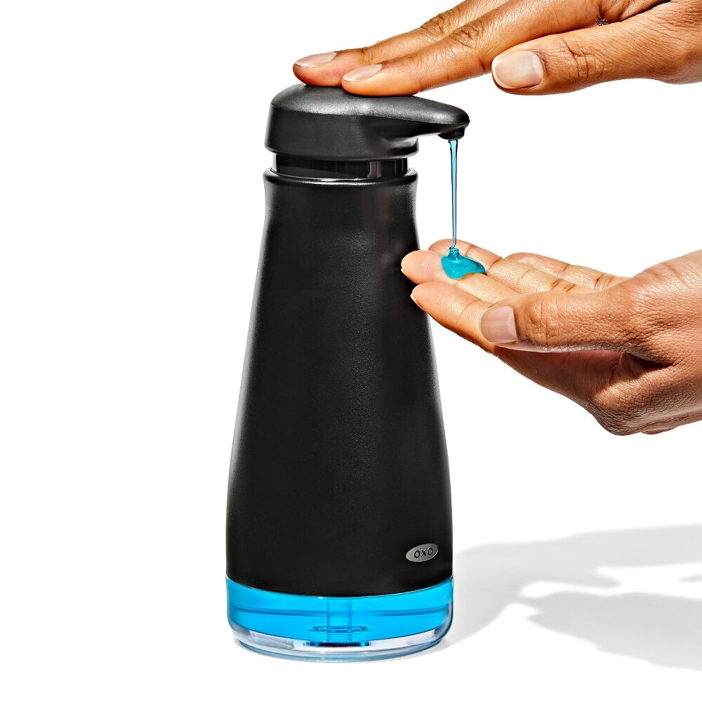 OXO Black soap dispenser with hands dispensing soap onto a hand.