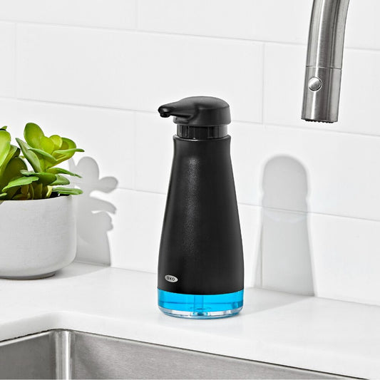 OXO Black soap dispenser with blue base on a kitchen counter