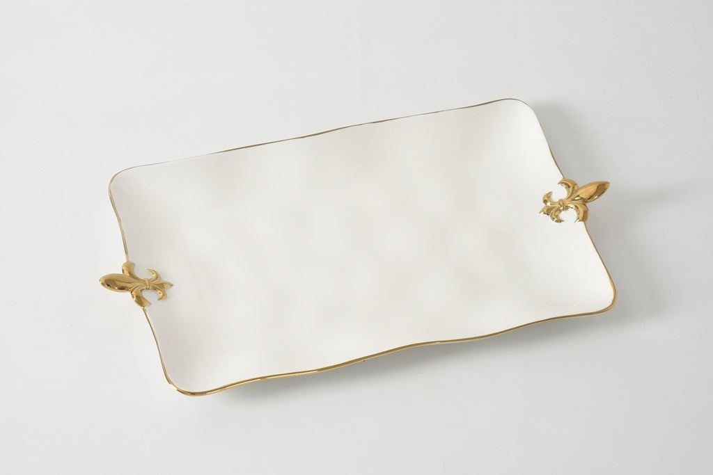 Rectangular white dish with gold handles on a light gray background