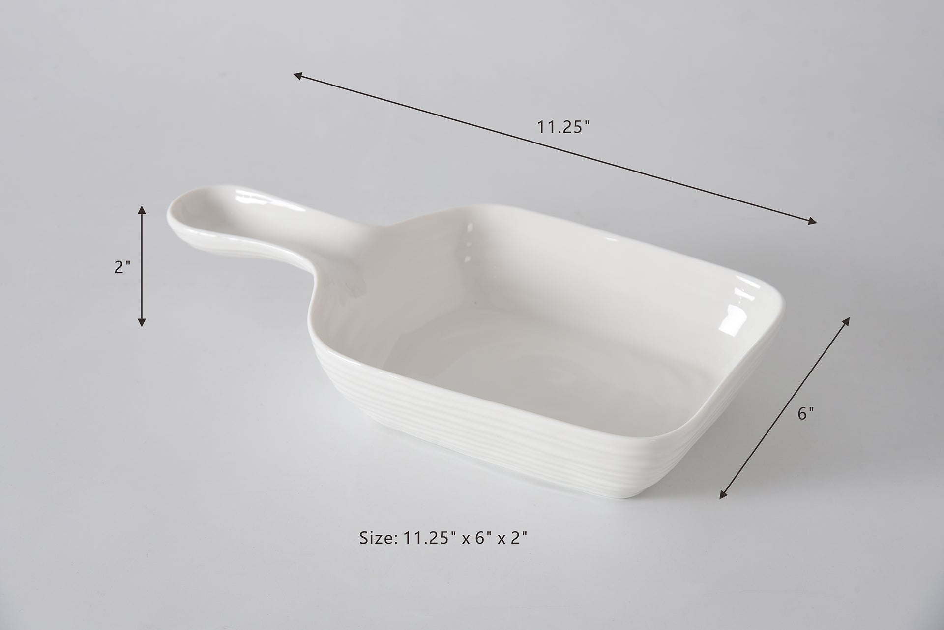 White ceramic casserole dish with dimensions labeled on a gray background