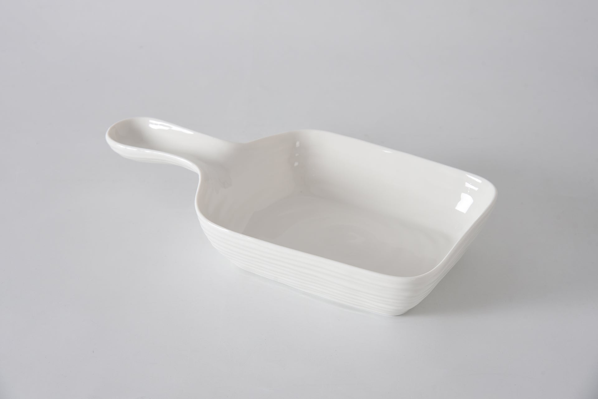 White ceramic dish on a light gray background