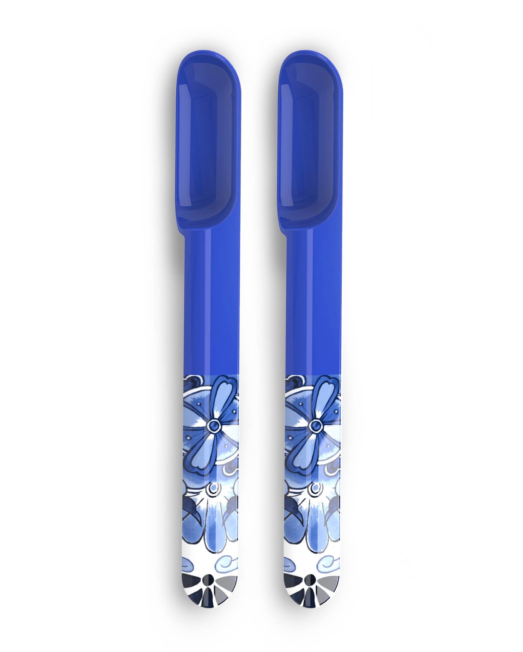 Two blue melamine spoons with floral patterns on a white background