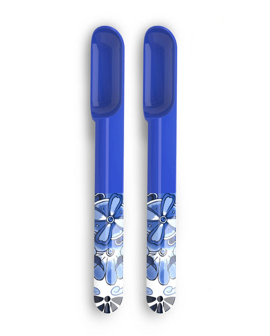 Two blue melamine spoons with floral patterns on a white background