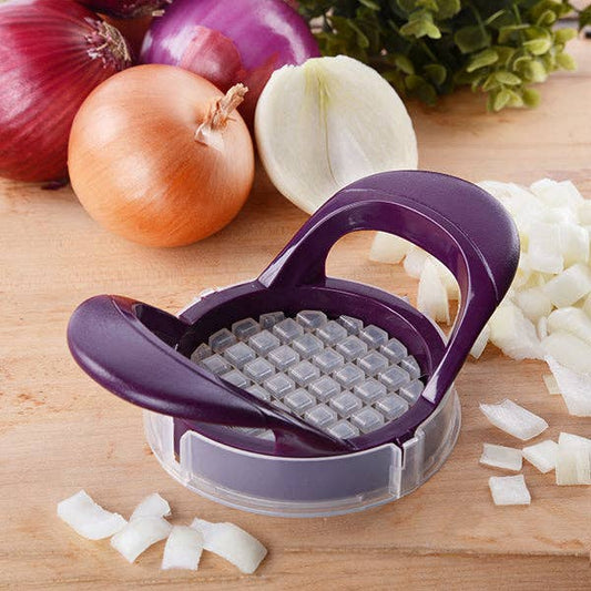 Purple onion chopper on a wooden cutting board with chopped onions and whole onions.