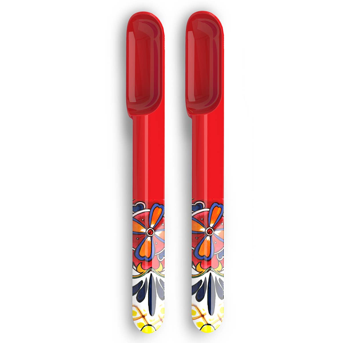 Two red melamine spoons with colorful  designs on a white background