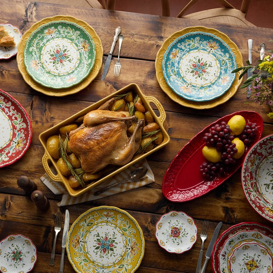 Decorative plates with a roasted chicken on a wooden table