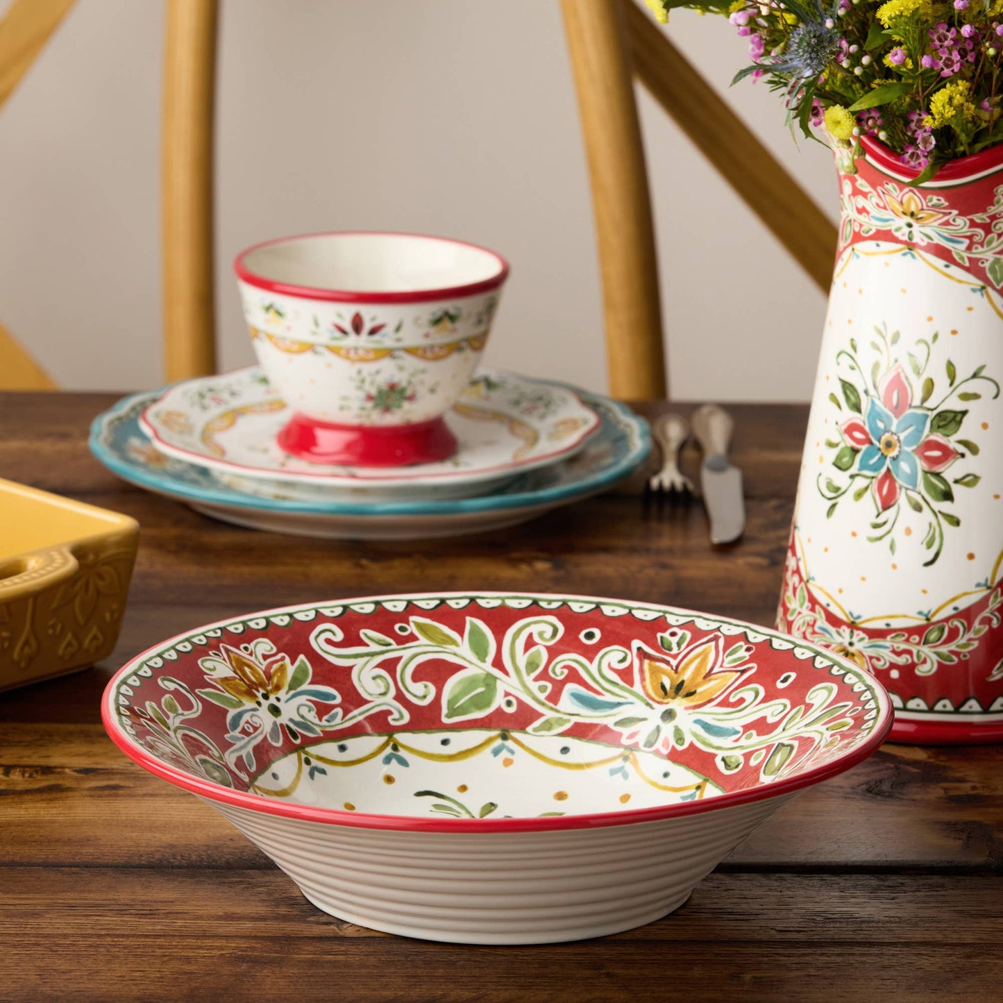 Decorative ceramic bowl with floral patterns on a wooden table.