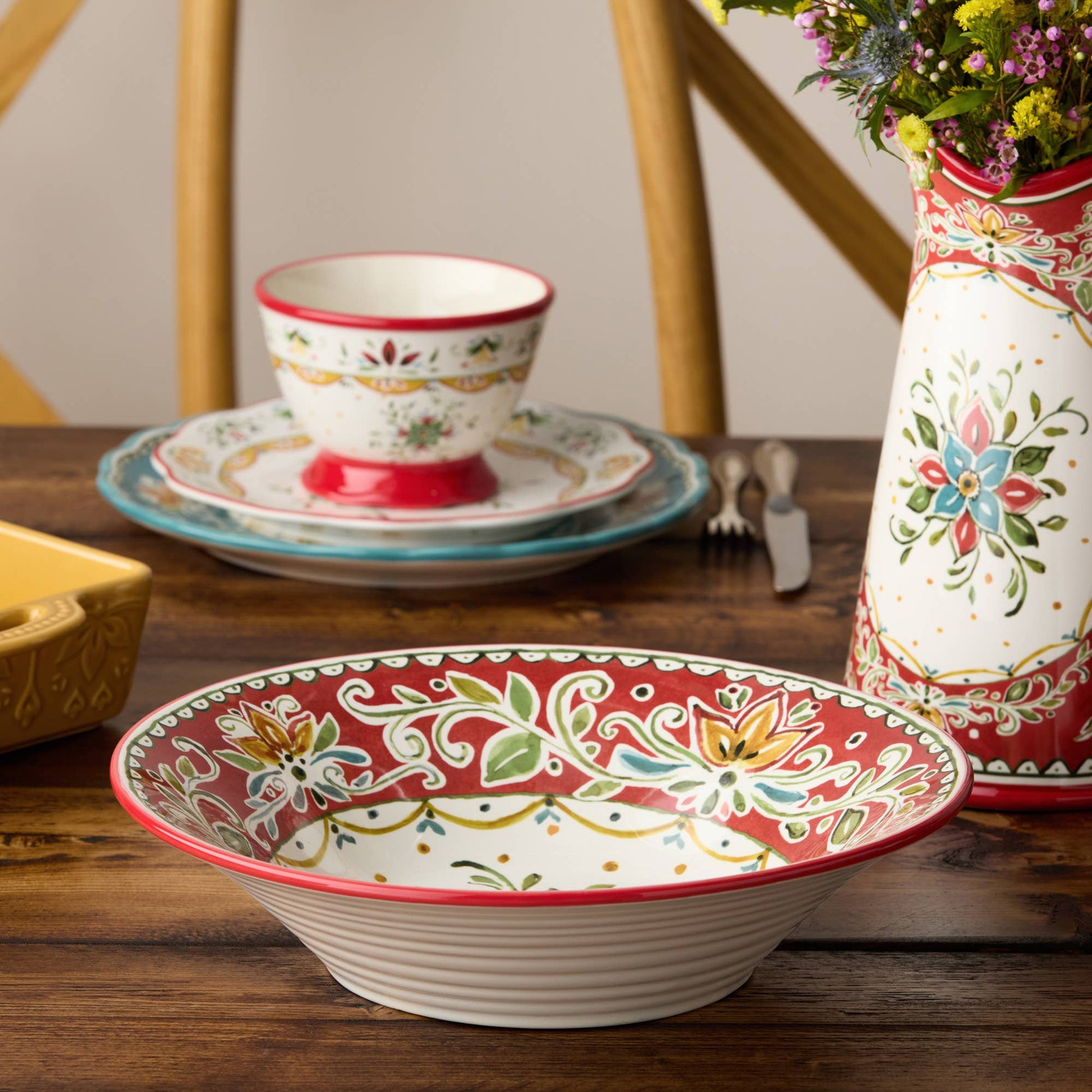 Decorative ceramic bowl with floral patterns on a wooden table.
