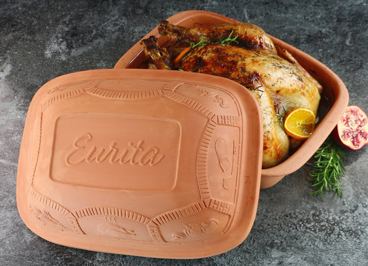 Terracotta dish with roasted chicken branding on a gray surface
