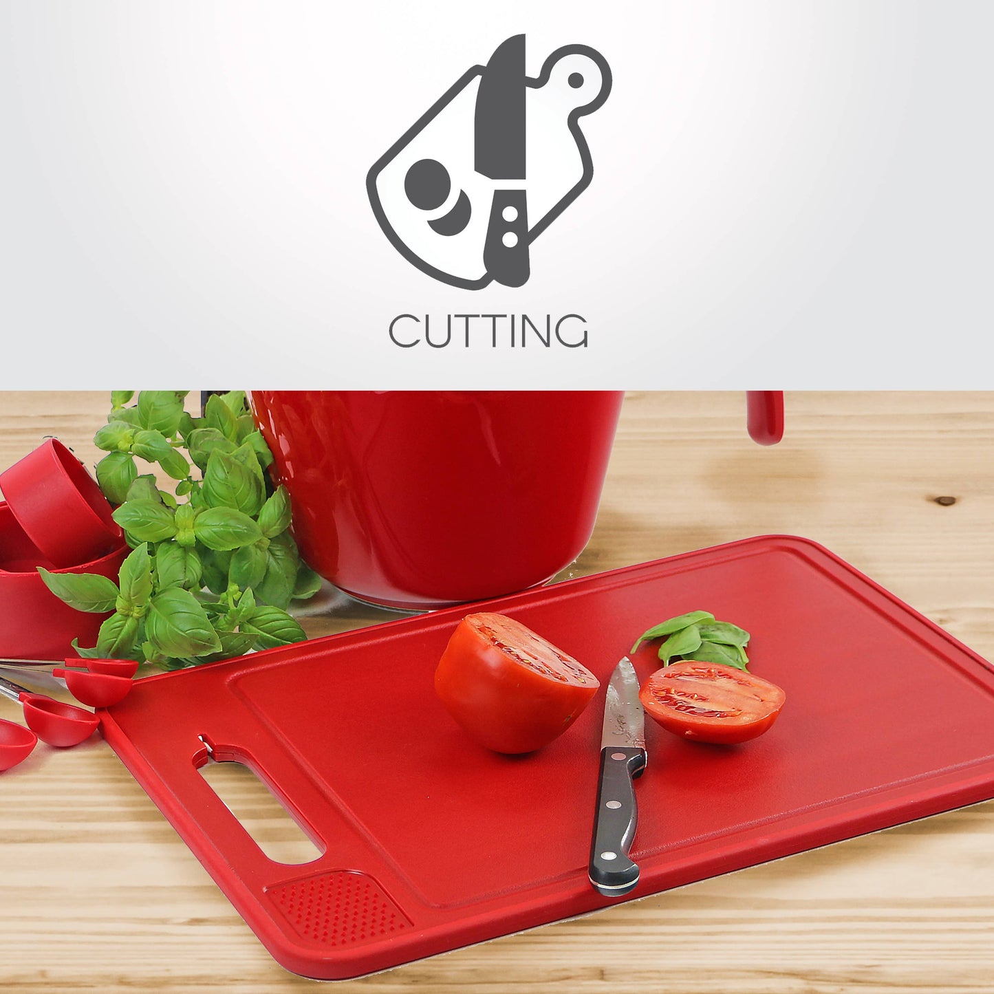 Red cutting board with a knife and sliced tomatoes on a wooden surface, with a red bowl and green herbs in the background.