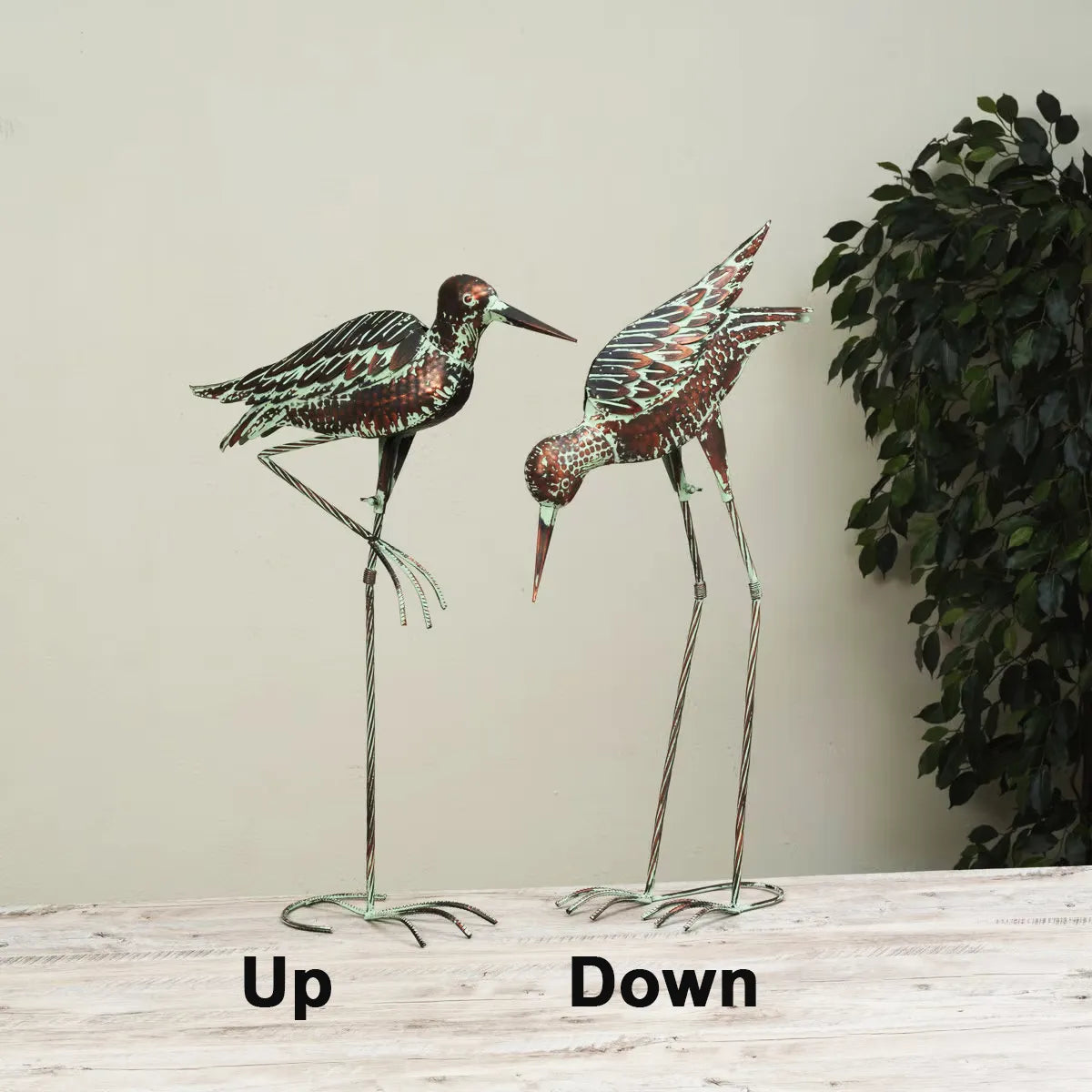 Two decorative bird figures on stands with 'Up' and 'Down' labels against a neutral background.