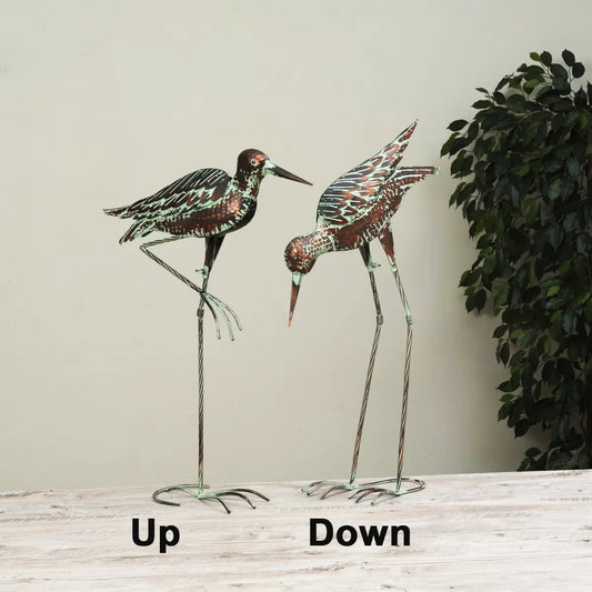 Two decorative bird figures on stands with 'Up' and 'Down' labels against a neutral background.