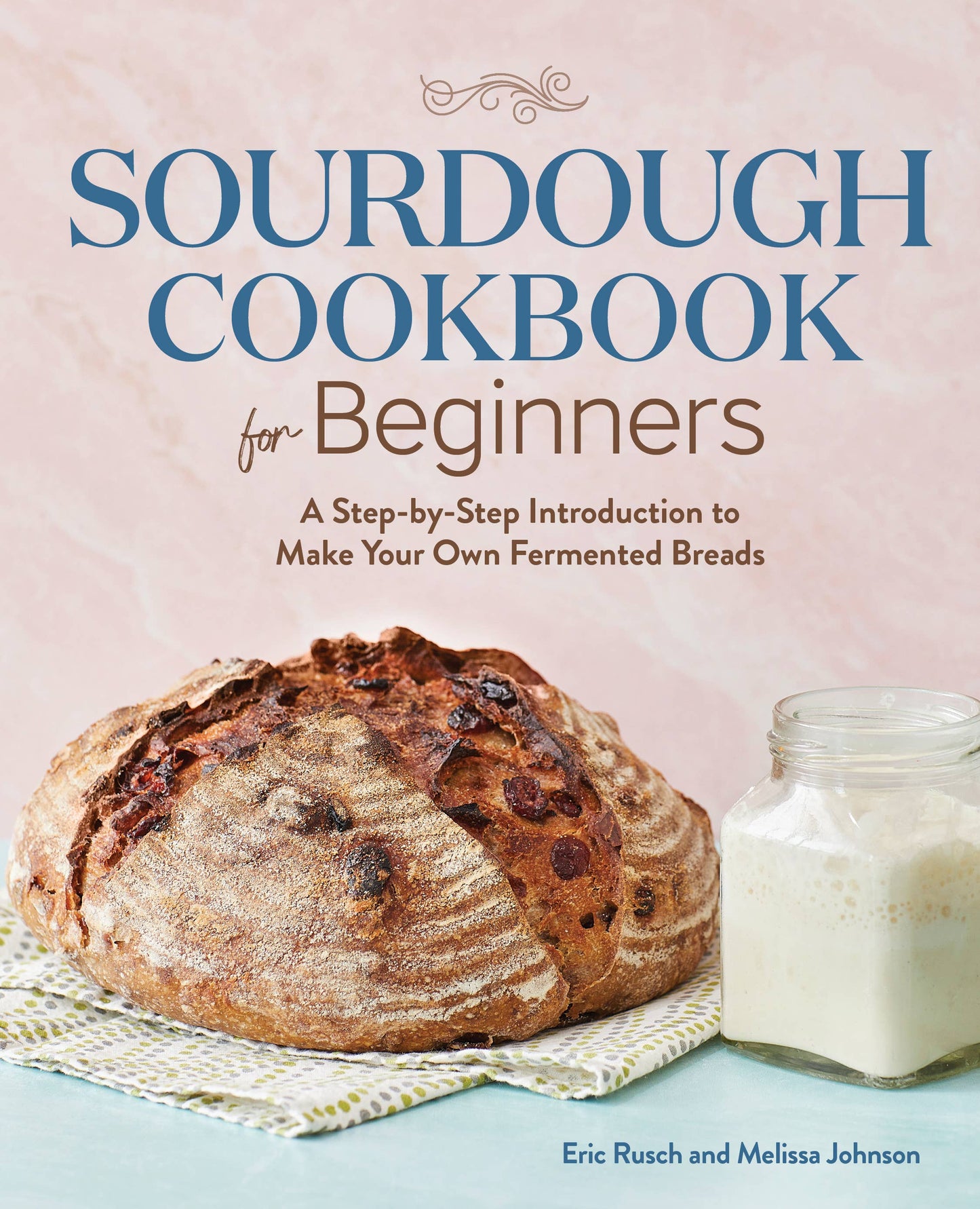 Sourdough Cookbook for Beginners with a loaf of bread and jar on a light background