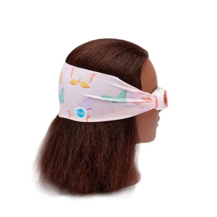 Mannequin head with colorful flamingo-patterned headband on a white background