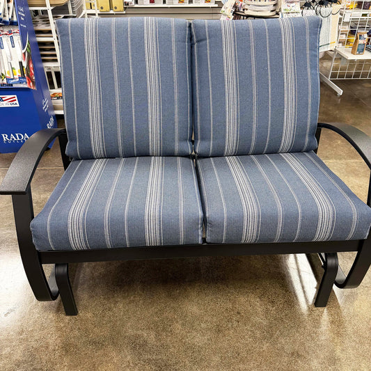 Blue striped outdoor loveseat in a store setting