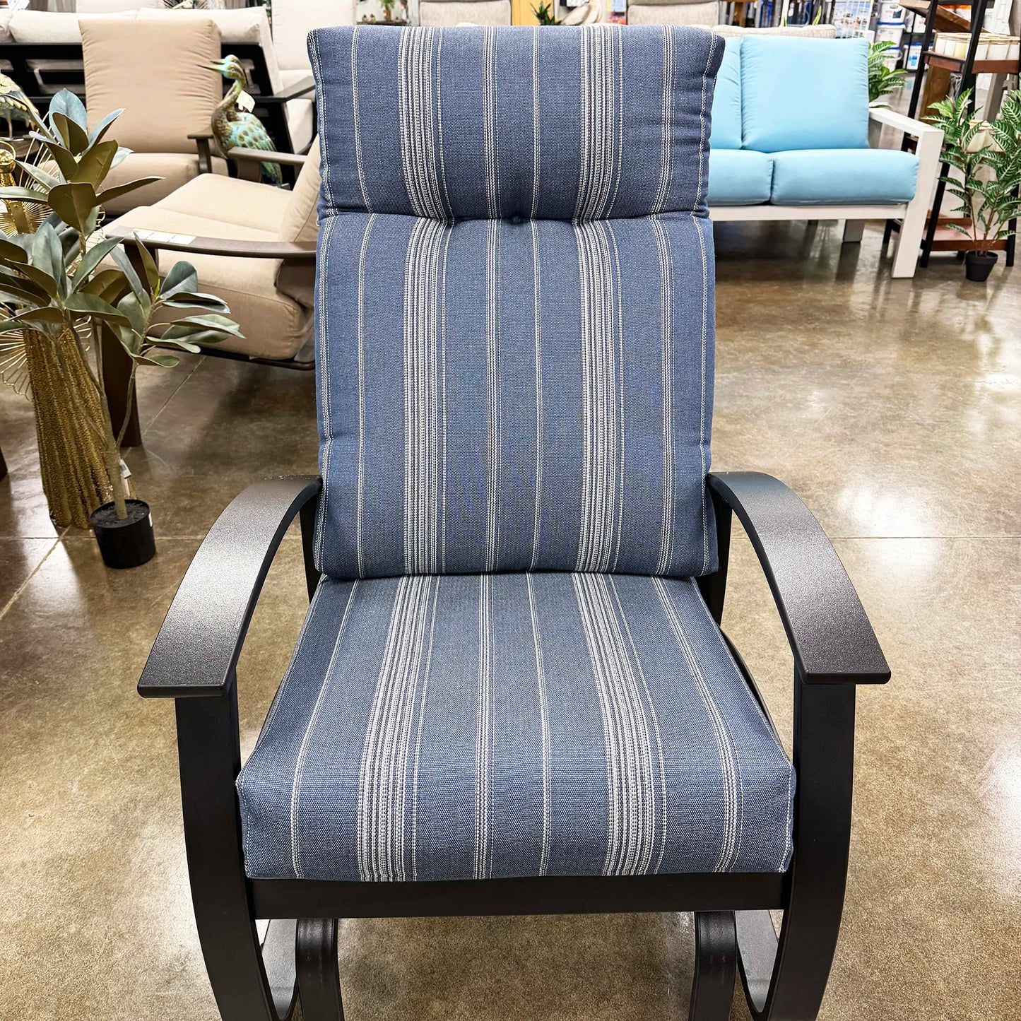 Blue striped chair with black frame in a showroom setting