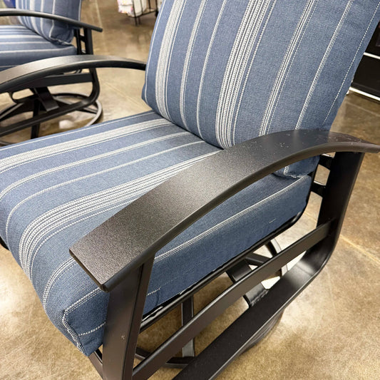 Blue and white striped chair with black metal frame on a concrete floor.