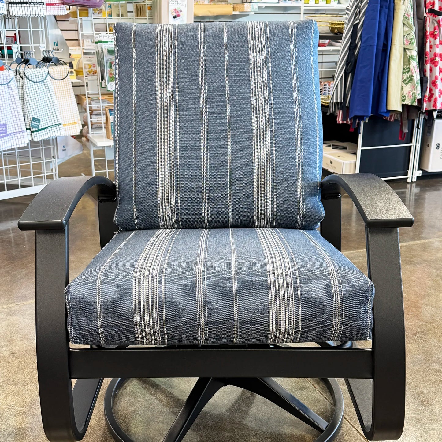 Blue striped chair with black frame in a store setting