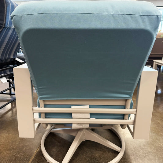 Chair with blue cushion on a concrete floor