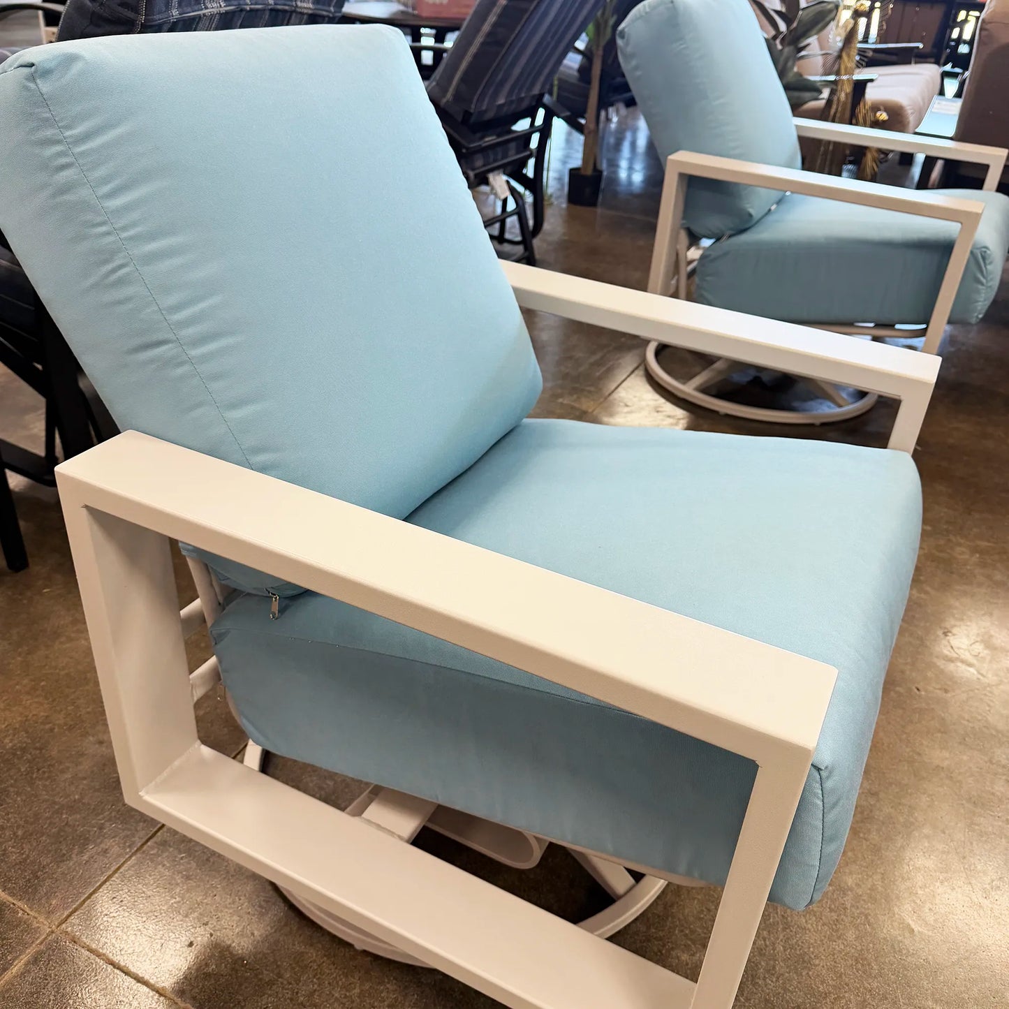 Light blue chair with white frame in a room setting