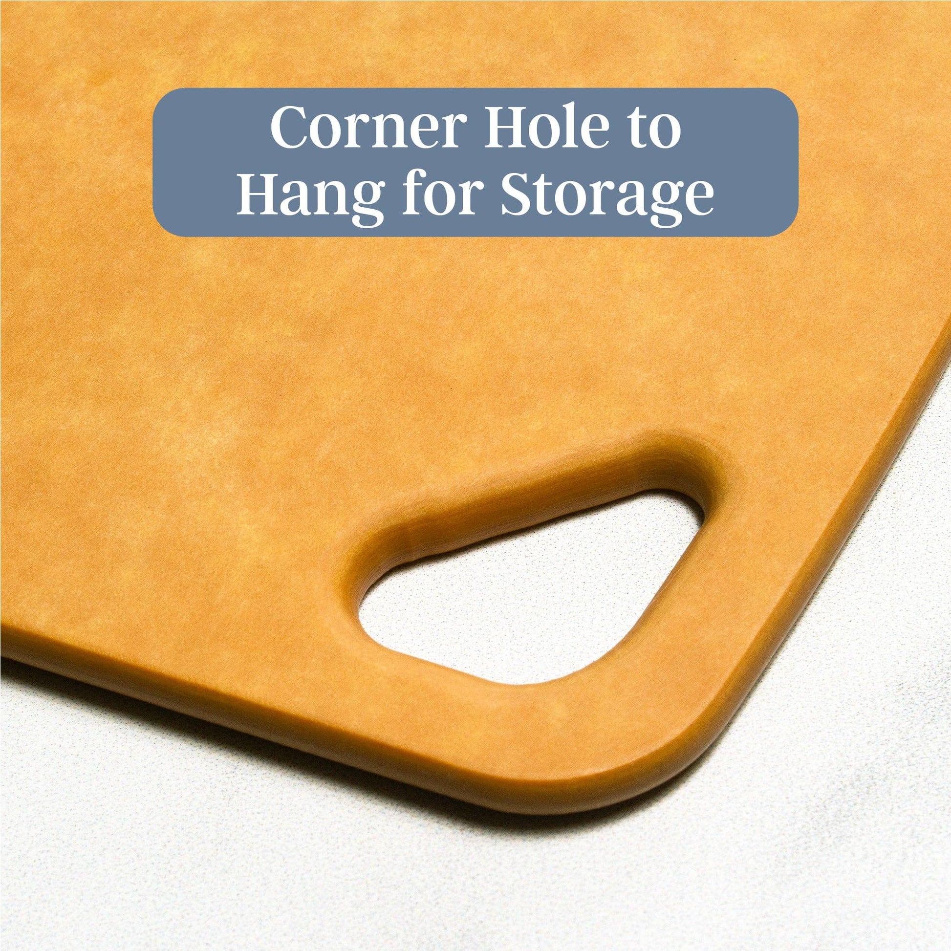 Brown cutting board with a corner hole for storage on a white background