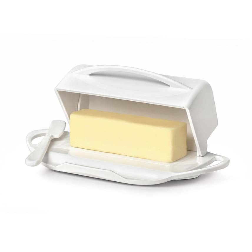 White butter dish with a stick of butter on a white background