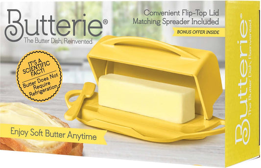 Yellow Butterie butter dish with a block of butter on a wooden surface