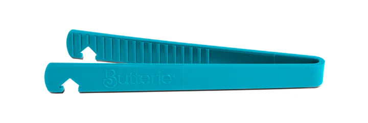 Turquoise toaster tong on a white background