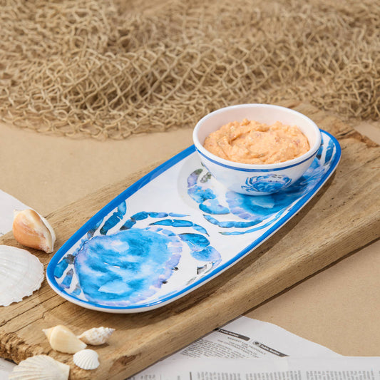 Decorative serving tray and bowl with blue crab design on a wooden surface