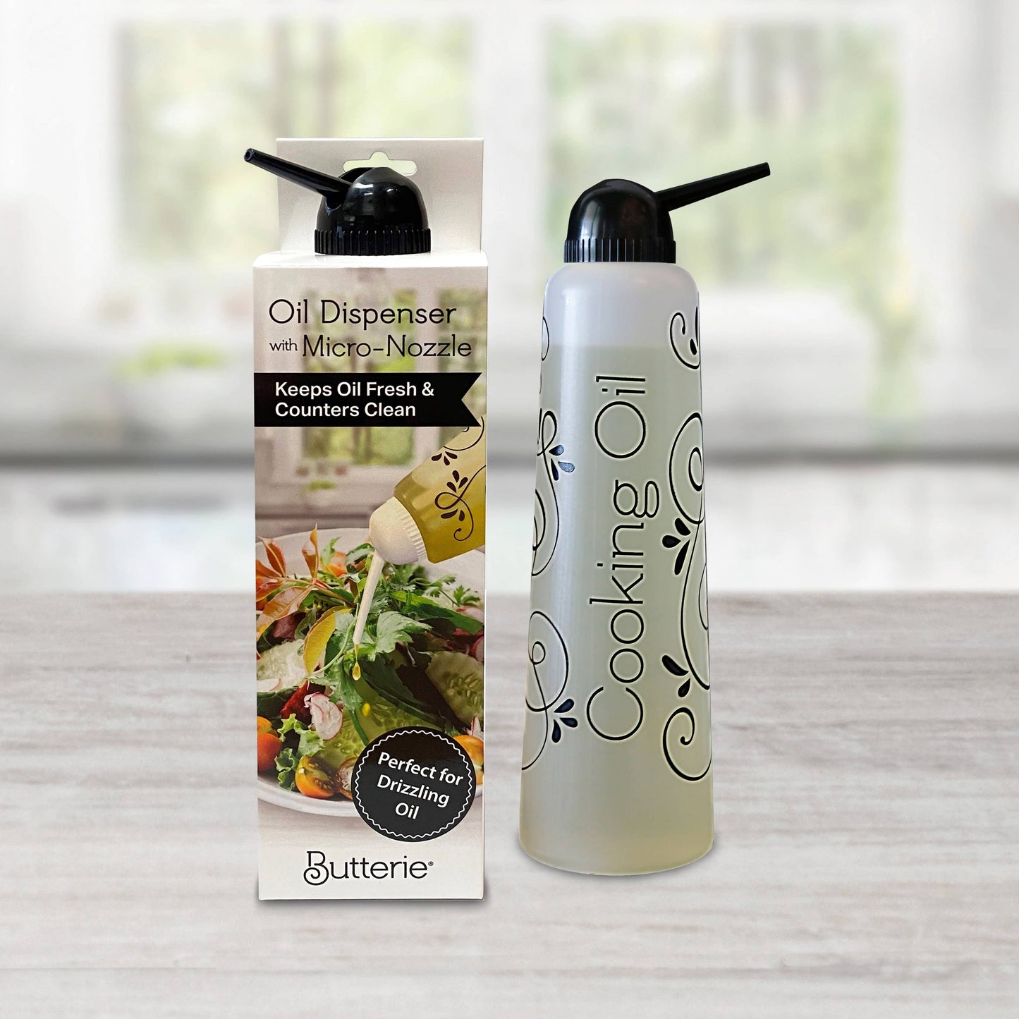 Butterie cooking oil dispenser with black cap and packaging on a neutral background
