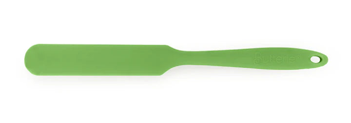 Green spatula on a white background