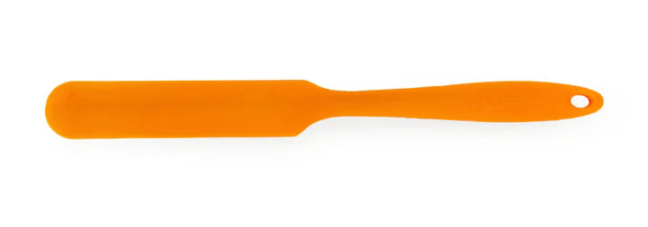 Orange spatula on a white background