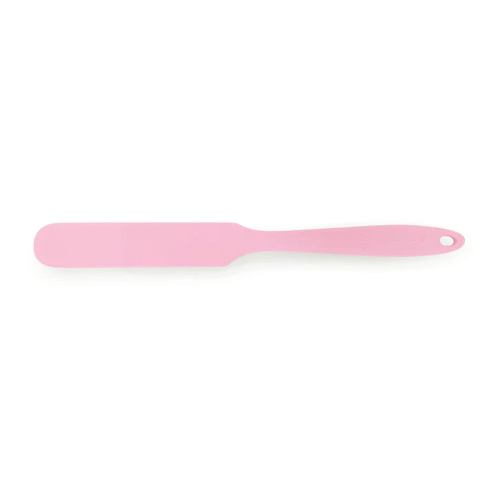 Pink spatula on a white background