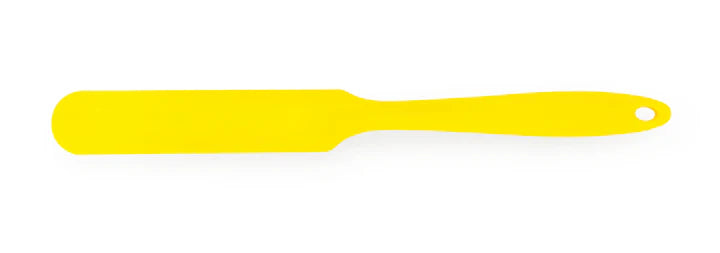 Yellow spatula on a white background