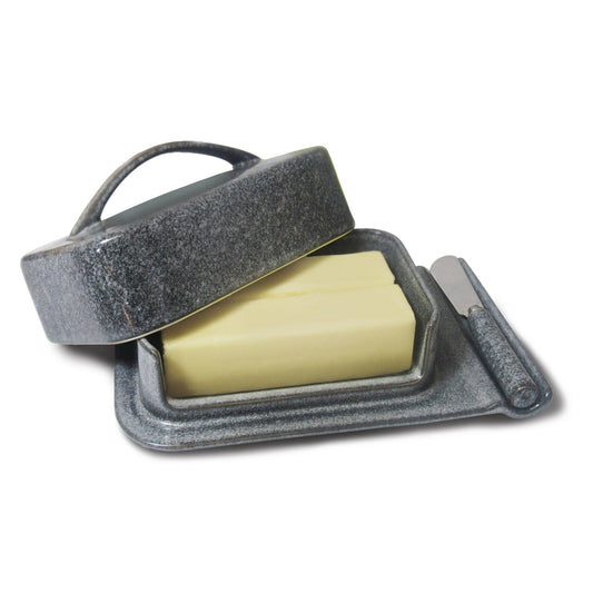 Gray butter dish with 2 sticks of butter and a knife on a white background