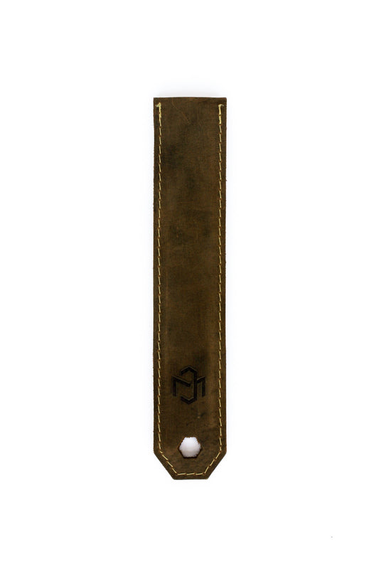 Brown leather strap with a white bead on a white background