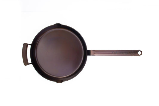 Blackcarbon steel skillet on a white background