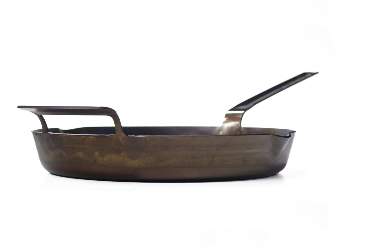 Carbon steel skillet on a white background