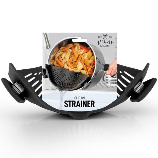 Black clip-on strainer basket shown in front of its retail packaging on a white background. The packaging features a photo of pasta being drained