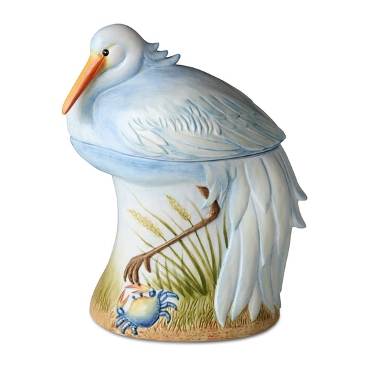 Decorative porcelain pelican cookie jar with a crab and grass design on a white background