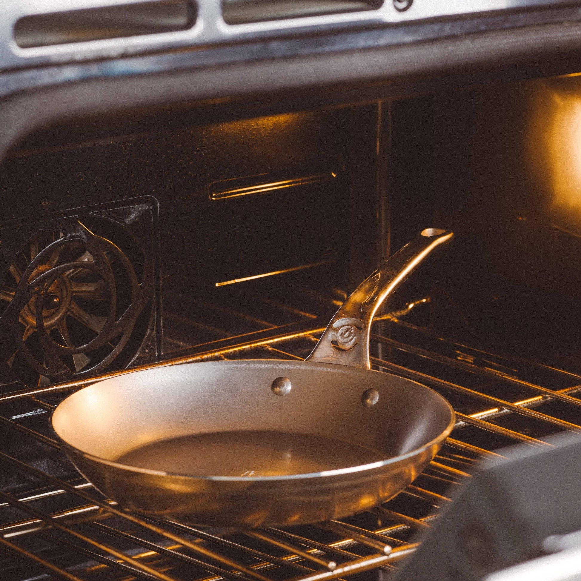 Frying pan inside an oven with a visible de Buyer logo.