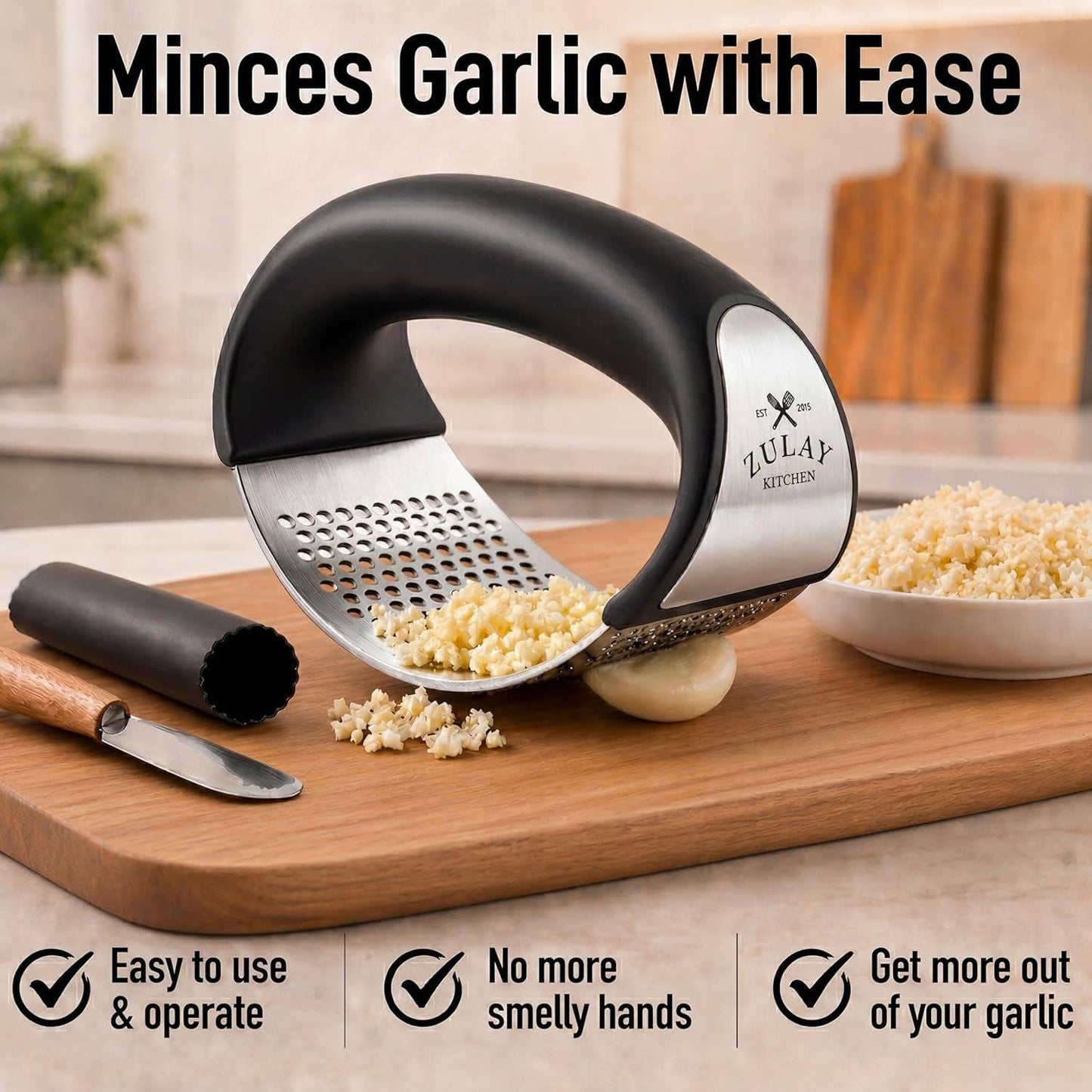 Garlic mincer on a cutting board with garlic and a bowl of minced garlic, branded as Zulay Kitchen.
