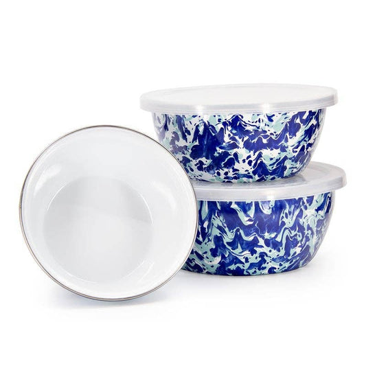 Two blue and white patterned storage bowls with lids on a white background