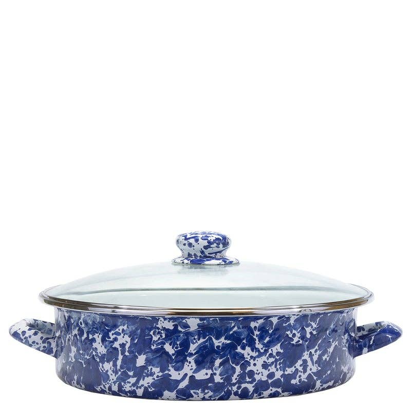 A round enamel lidded casserole dish with a blue and white marbled pattern, featuring side handles and a clear glass lid with a blue and white knob.